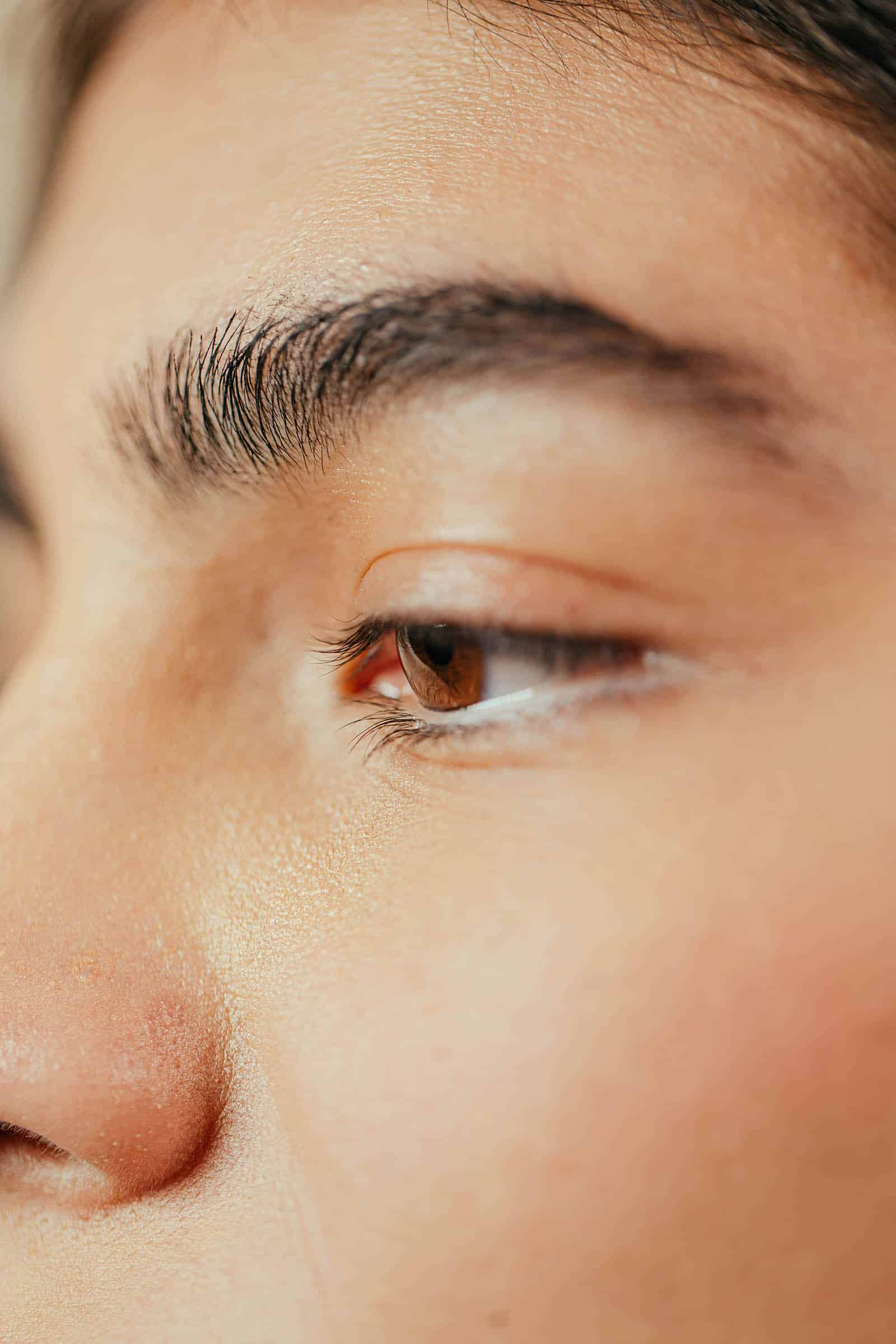 Extreme close-up of natural eyebrow showing hair-stroke detail for microblading