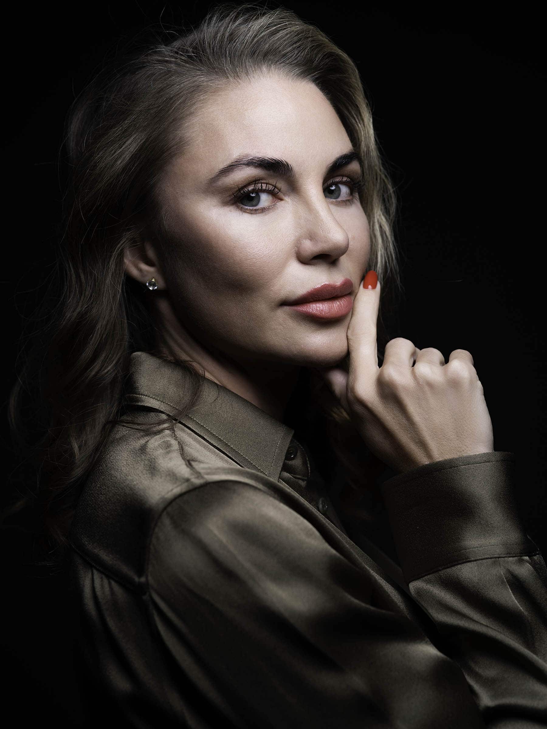 Woman with smooth, luminous skin in studio lighting, representing non-surgical facial rejuvenation